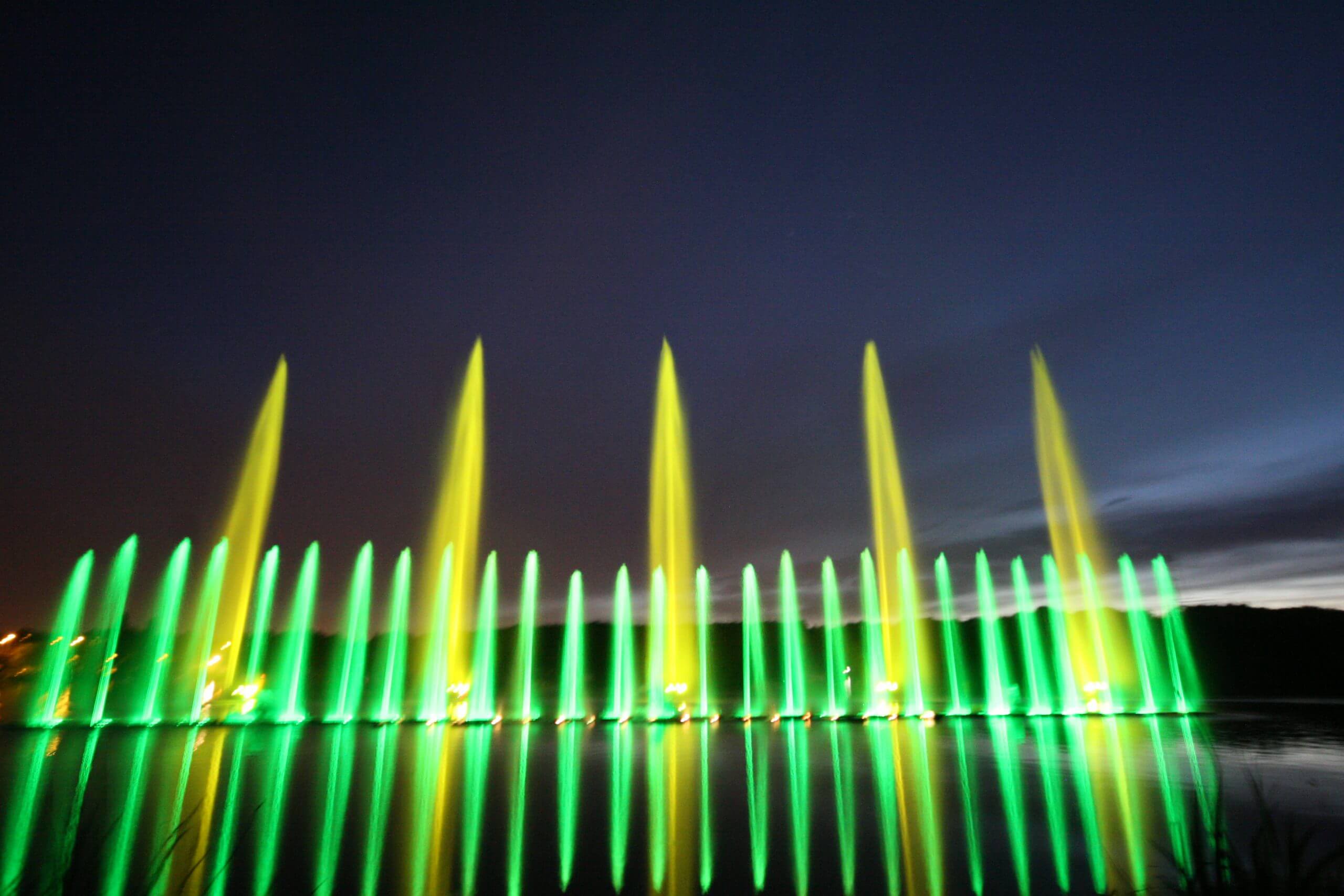 Atlantid - Photo of green and yellow water jets