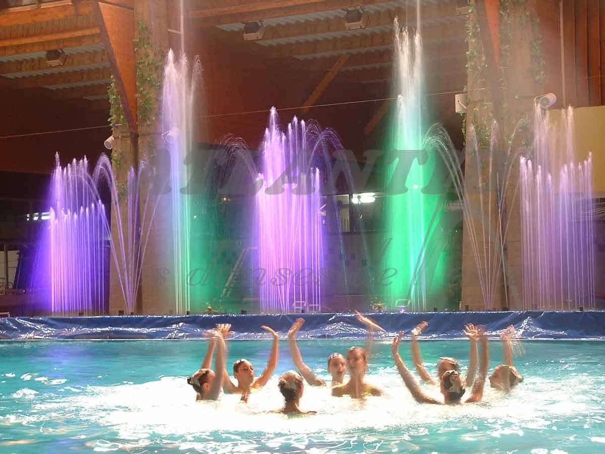 Atlantid - Inaugurations and anniversaries - Show of multicolored fountains with swimmers in front in a swimming pool