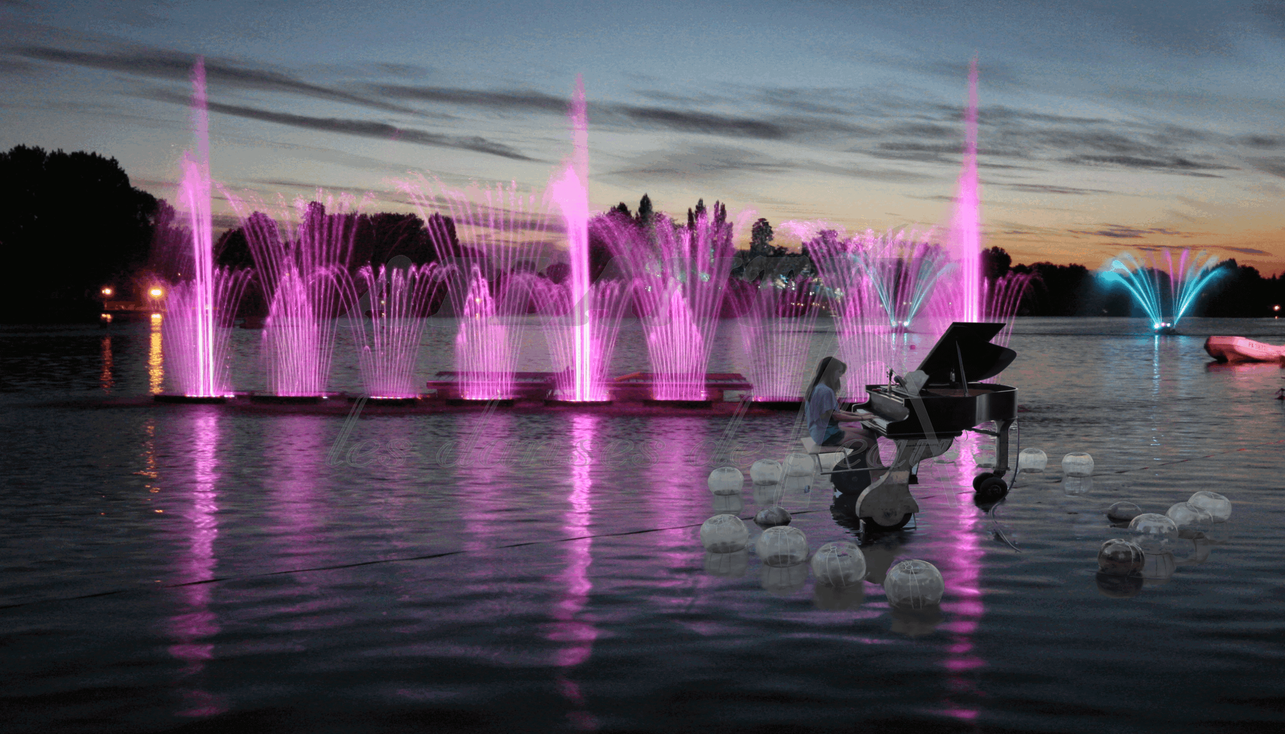 Atlantid - Body of water with pink water jets and pianist on the side
